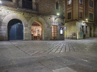 Night View of Barcelona City Street with Historic Architecture and Shopfronts