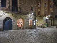 Night View of Barcelona City Street with Historic Architecture and Shopfronts