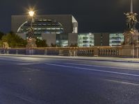 street at night with city lights, city streets and bridge on both sides of road