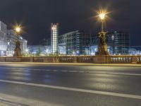 some street lights on a street and buildings at night time at city street with road and road