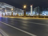 some street lights on a street and buildings at night time at city street with road and road