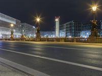 some street lights on a street and buildings at night time at city street with road and road