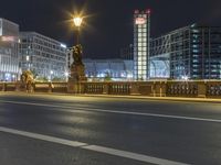 some street lights on a street and buildings at night time at city street with road and road