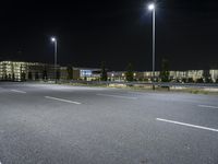 the night view shows several large buildings and streetlights near the roadway or other road