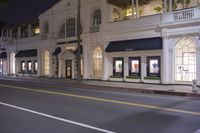 a building with lit lights on and street behind it that reads brooks brothers clothing company