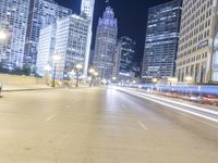 the lights are shining at night on the city street while cars pass by in a motion