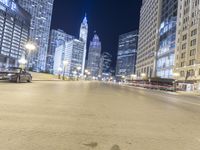 the lights are shining at night on the city street while cars pass by in a motion