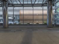 the front entrance of a modern building is clearly visible, and the glass curtained facade looks very empty