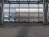the front entrance of a modern building is clearly visible, and the glass curtained facade looks very empty