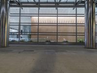 the front entrance of a modern building is clearly visible, and the glass curtained facade looks very empty