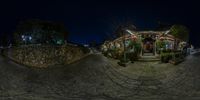 an image from fisheye of the building at night of a chinese restaurant and street