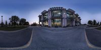 there is a view from the skateboard ramp at night time of a circular building