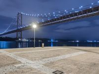 Night View of Coastal Bridge in Lisbon, Portugal