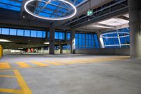 this is a parking garage with no people in it at night time under the neon lights