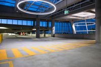 this is a parking garage with no people in it at night time under the neon lights