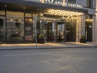 a car driving past a building with a sign that says crown grand central hotel and spa