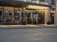 a car driving past a building with a sign that says crown grand central hotel and spa