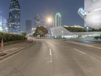 empty roads with tall buildings in the background at night hours and blue hour to the right