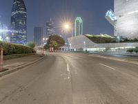 empty roads with tall buildings in the background at night hours and blue hour to the right