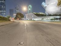 empty roads with tall buildings in the background at night hours and blue hour to the right