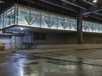 an empty parking garage is illuminated by the low light from the windows that go underneath