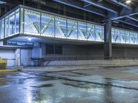 an empty parking garage is illuminated by the low light from the windows that go underneath