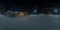 a night scene of an empty parking lot at a mall with parking lots around it