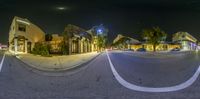 an image of a night view of an intersection in a city of small town buildings