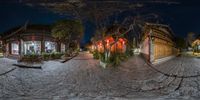 360 - view showing city street, sidewalk and trees at night with red lights, in a spherical panorama style