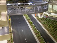 a view of a road and an overpass with traffic passing through it by buildings