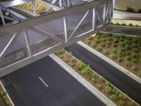 a view of a road and an overpass with traffic passing through it by buildings