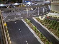 a view of a road and an overpass with traffic passing through it by buildings