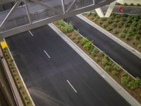 a view of a road and an overpass with traffic passing through it by buildings