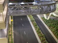 a view of a road and an overpass with traffic passing through it by buildings