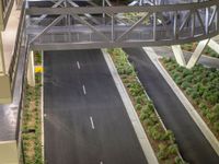 a view of a road and an overpass with traffic passing through it by buildings