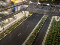 a view of a road and an overpass with traffic passing through it by buildings