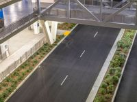 a view of a road and an overpass with traffic passing through it by buildings