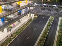 a view of a road and an overpass with traffic passing through it by buildings