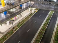 a view of a road and an overpass with traffic passing through it by buildings