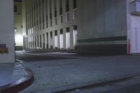 the street has two streetside doors lit up in yellow and black at night,