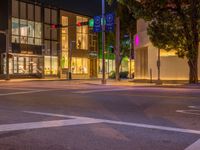 a view of a city street at night in front of the museum of art and design