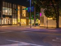 a view of a city street at night in front of the museum of art and design