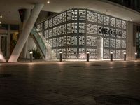 an image of a building that is lit up at night with multiple lights above it