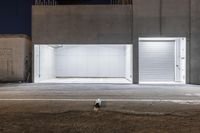 an image of two buildings outside at night with no one inside at the front door