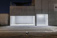 an image of two buildings outside at night with no one inside at the front door