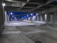 an empty parking garage with no people in it at night time time with only one stop sign