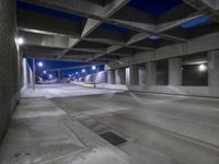 an empty parking garage with no people in it at night time time with only one stop sign