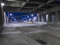 an empty parking garage with no people in it at night time time with only one stop sign
