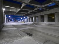 an empty parking garage with no people in it at night time time with only one stop sign