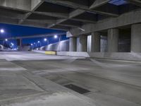 an empty parking garage with no people in it at night time time with only one stop sign